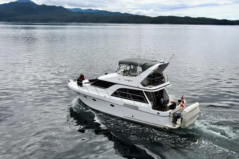  Yacht Photos Pics 1998 Ocean Alexander 420 yacht cruising on calm waters with scenic mountain backdrop.