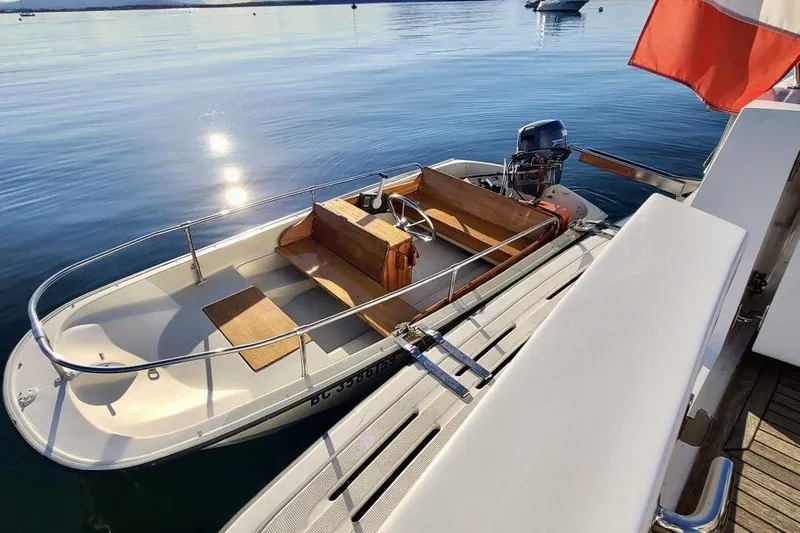  Yacht Photos Pics 1998 Ocean Alexander 420 boat docked on calm water, with wooden seating and outboard motor.