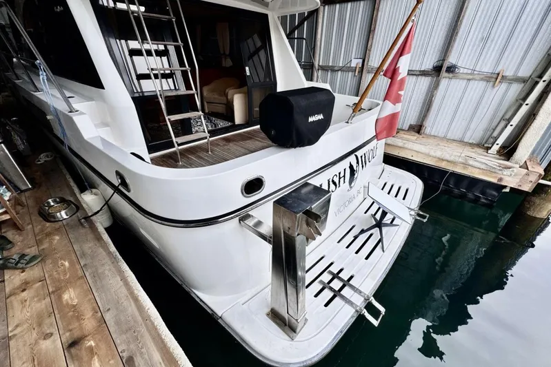  Yacht Photos Pics 1998 Ocean Alexander 420 yacht docked, featuring a spacious deck and Canadian flag.