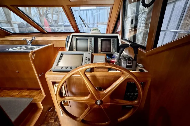  Yacht Photos Pics 1998 Ocean Alexander 420 helm with wooden steering wheel and navigation equipment.