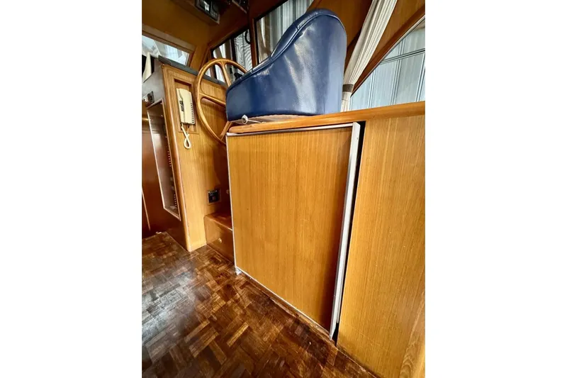  Yacht Photos Pics Interior of 1998 Ocean Alexander 420 yacht with wooden cabinetry and blue seating.