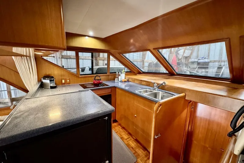  Yacht Photos Pics Interior of 1998 Ocean Alexander 420 yacht, featuring a modern kitchen with wood finishes.