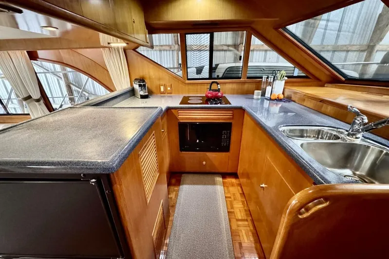  Yacht Photos Pics Luxurious 1998 Ocean Alexander 420 yacht kitchen with modern amenities and elegant wood finish.