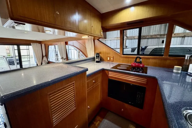  Yacht Photos Pics Interior of 1998 Ocean Alexander 420 yacht kitchen with modern appliances and wood cabinetry.