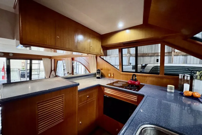  Yacht Photos Pics Luxurious 1998 Ocean Alexander 420 yacht kitchen with modern amenities and wood cabinetry.