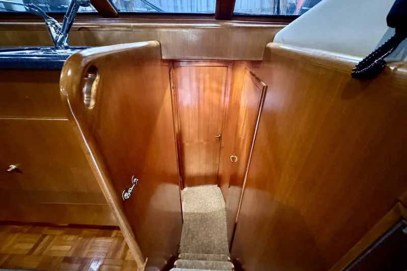  Yacht Photos Pics Interior view of 1998 Ocean Alexander 420 yacht, featuring wooden stairs and cabinetry.