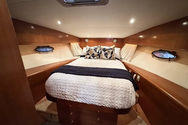  Yacht Photos Pics Luxurious cabin interior of 1998 Ocean Alexander 420 yacht with cozy bedding and wood finish.