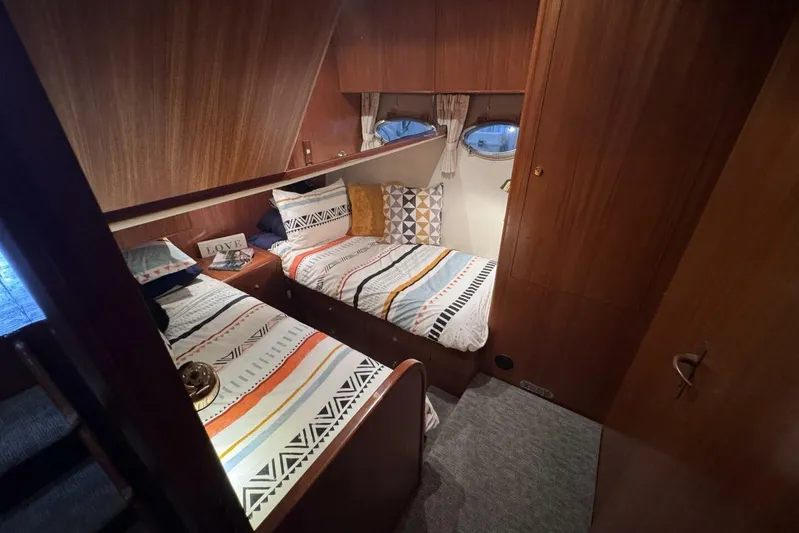  Yacht Photos Pics Cozy cabin interior of 1998 Ocean Alexander 420 yacht with twin beds and wooden paneling.