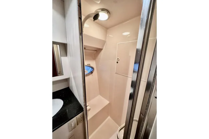  Yacht Photos Pics 1998 Ocean Alexander 420 yacht bathroom with shower, sink, and mirror.