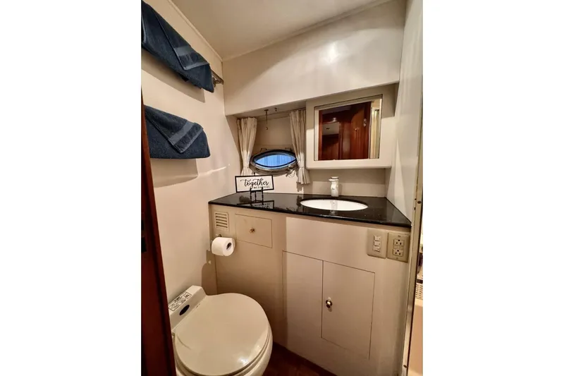  Yacht Photos Pics Bathroom interior of 1998 Ocean Alexander 420 yacht with sink, toilet, and mirror.
