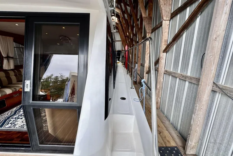  Yacht Photos Pics 1998 Ocean Alexander 420 yacht interior with sliding glass door and wooden dock.