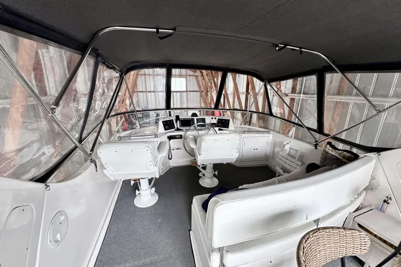  Yacht Photos Pics 1998 Ocean Alexander 420 yacht interior with helm, seating, and enclosed canopy.