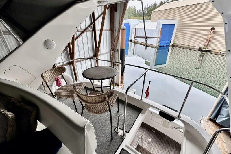  Yacht Photos Pics 1998 Ocean Alexander 420 yacht deck with wicker chairs and table, docked in marina.