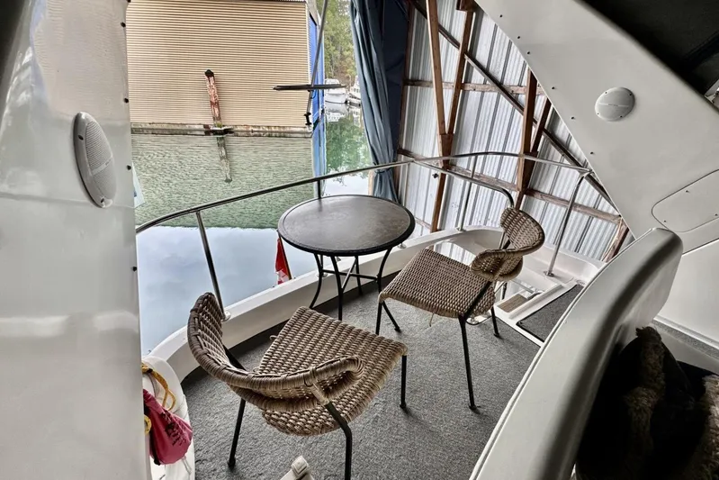  Yacht Photos Pics 1998 Ocean Alexander 420 yacht deck with wicker chairs and table, docked in a marina.