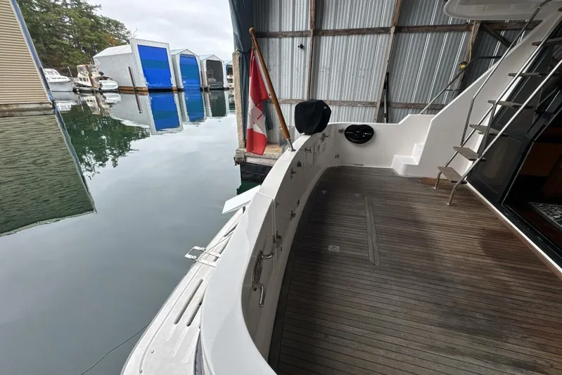  Yacht Photos Pics 1998 Ocean Alexander 420 yacht docked, featuring wooden deck and marina view.