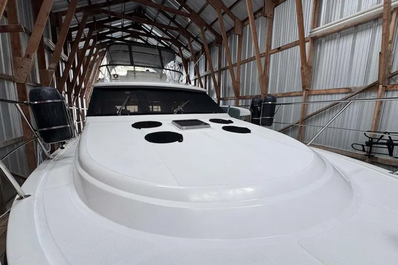  Yacht Photos Pics 1998 Ocean Alexander 420 yacht in covered storage, showcasing sleek design and spacious deck.