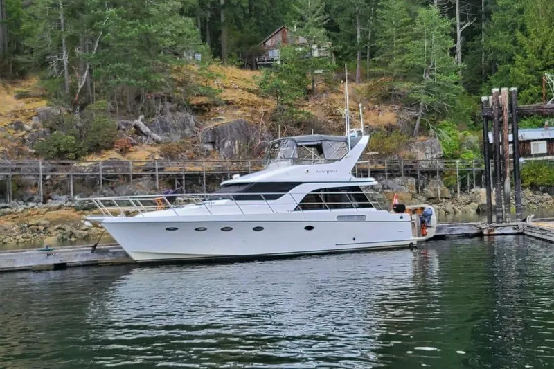  Yacht Photos Pics 1998 Ocean Alexander 420 yacht docked in a scenic, forested marina.