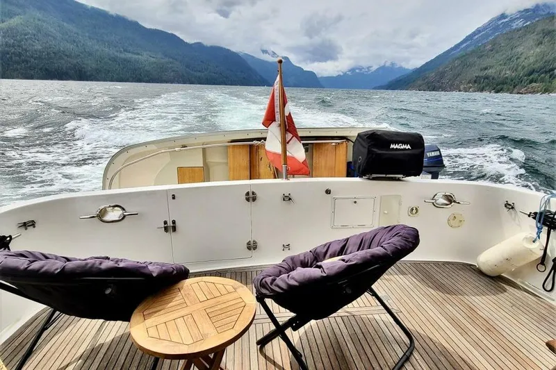  Yacht Photos Pics Ocean Alexander 420 yacht deck with chairs, table, and scenic mountain view, 1998 model.