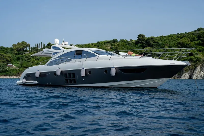 Barba III Yacht Photos Pics 2013 Azimut AZ 62S ITALIA yacht on serene blue water, lush green shoreline in background.
