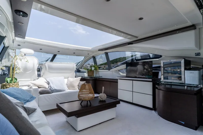 Barba III Yacht Photos Pics Luxurious interior of 2013 Azimut AZ 62S ITALIA yacht with modern furnishings and panoramic windows.