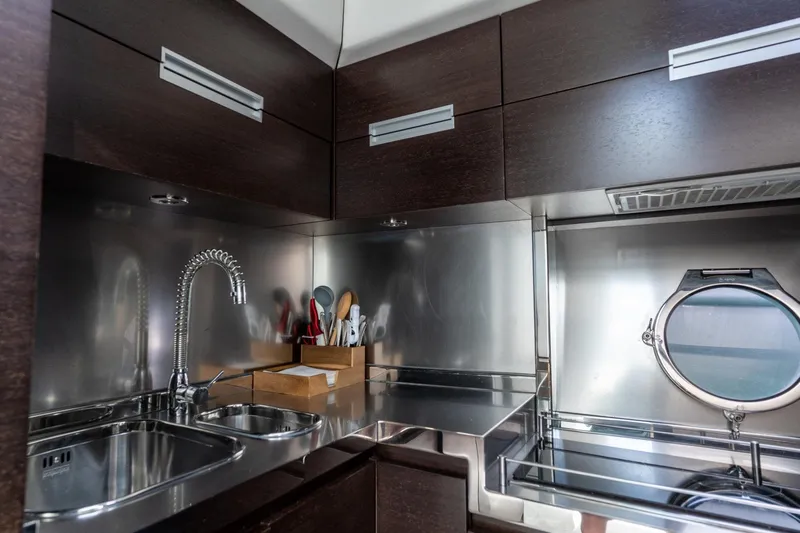 Barba III Yacht Photos Pics Modern kitchen interior on 2013 Azimut AZ 62S ITALIA yacht, featuring sleek cabinetry and stainless steel finishes.