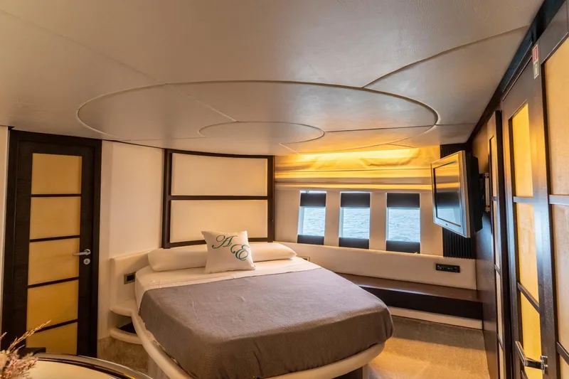 Barba III Yacht Photos Pics Luxurious bedroom interior of 2013 Azimut AZ 62S ITALIA yacht with modern design elements.