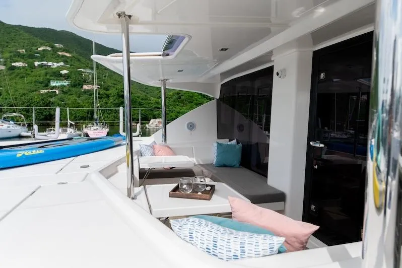 Ruby One Yacht Photos Pics Luxurious Leopard 58 yacht deck with seating, cushions, and scenic marina view, 2020 model.