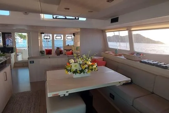 Ruby One Yacht Photos Pics Luxurious interior of a 2020 Leopard 58 yacht with elegant dining area and ocean view.