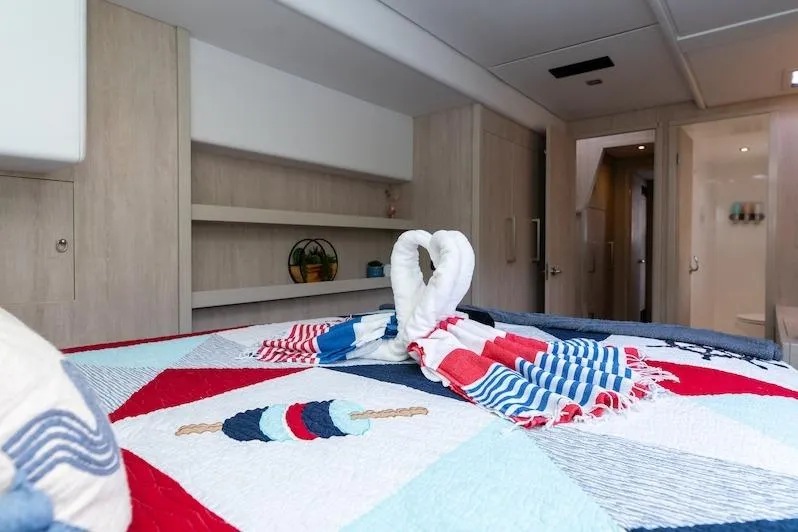 Ruby One Yacht Photos Pics Luxurious Leopard 58 yacht interior with colorful quilt and towel swans, 2020 model.