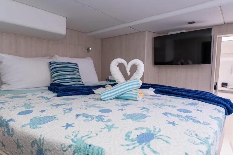 Ruby One Yacht Photos Pics Luxurious cabin interior of 2020 Leopard 58 yacht with nautical-themed bedding.