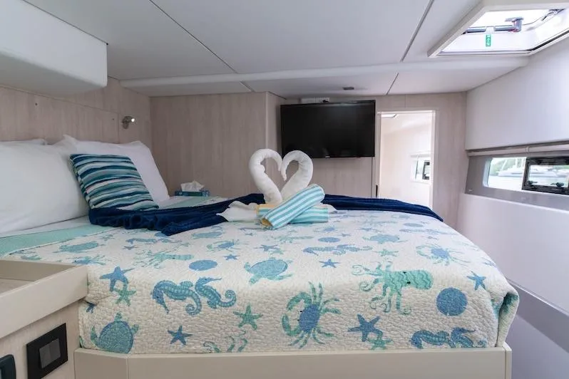 Ruby One Yacht Photos Pics Luxurious Leopard 58 yacht bedroom with ocean-themed bedding and elegant towel swans, 2020 model.
