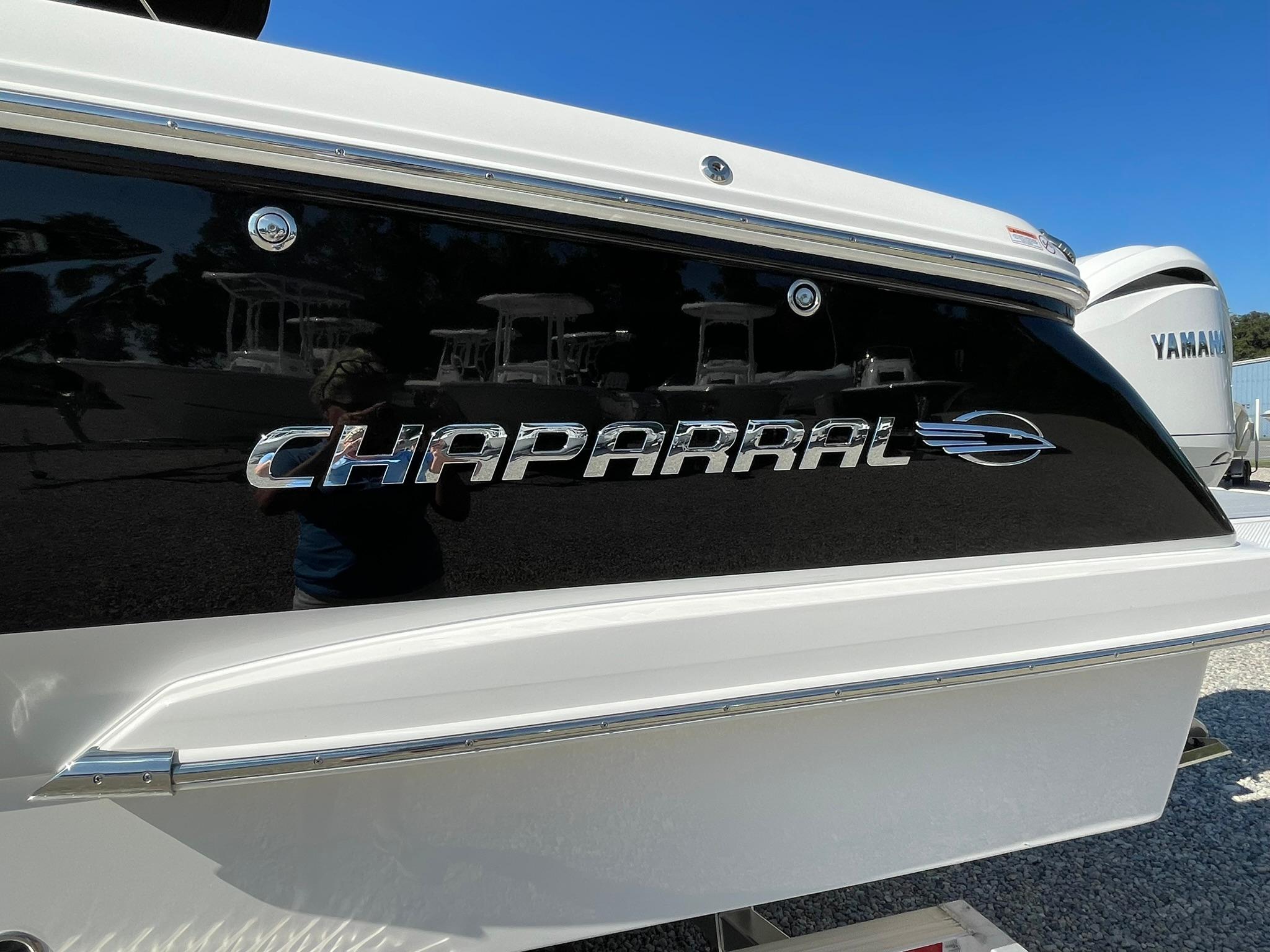 2025 Chaparral 270 OSX boat with sleek black and white design.