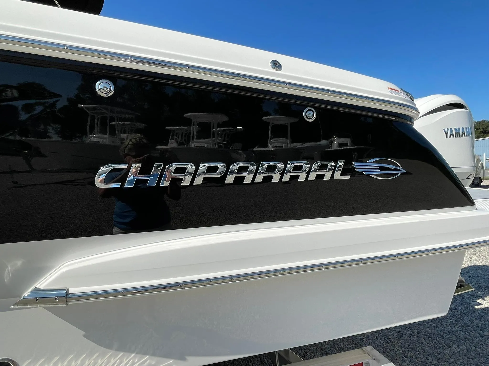 2025 Chaparral 270 OSX boat with sleek black and white design.