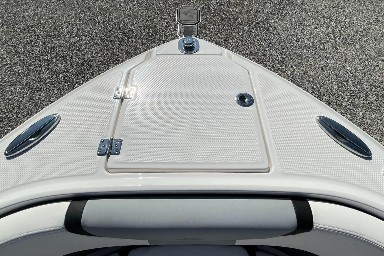 Bow view of 2025 Chaparral 270 OSX boat, featuring sleek design and storage hatch.