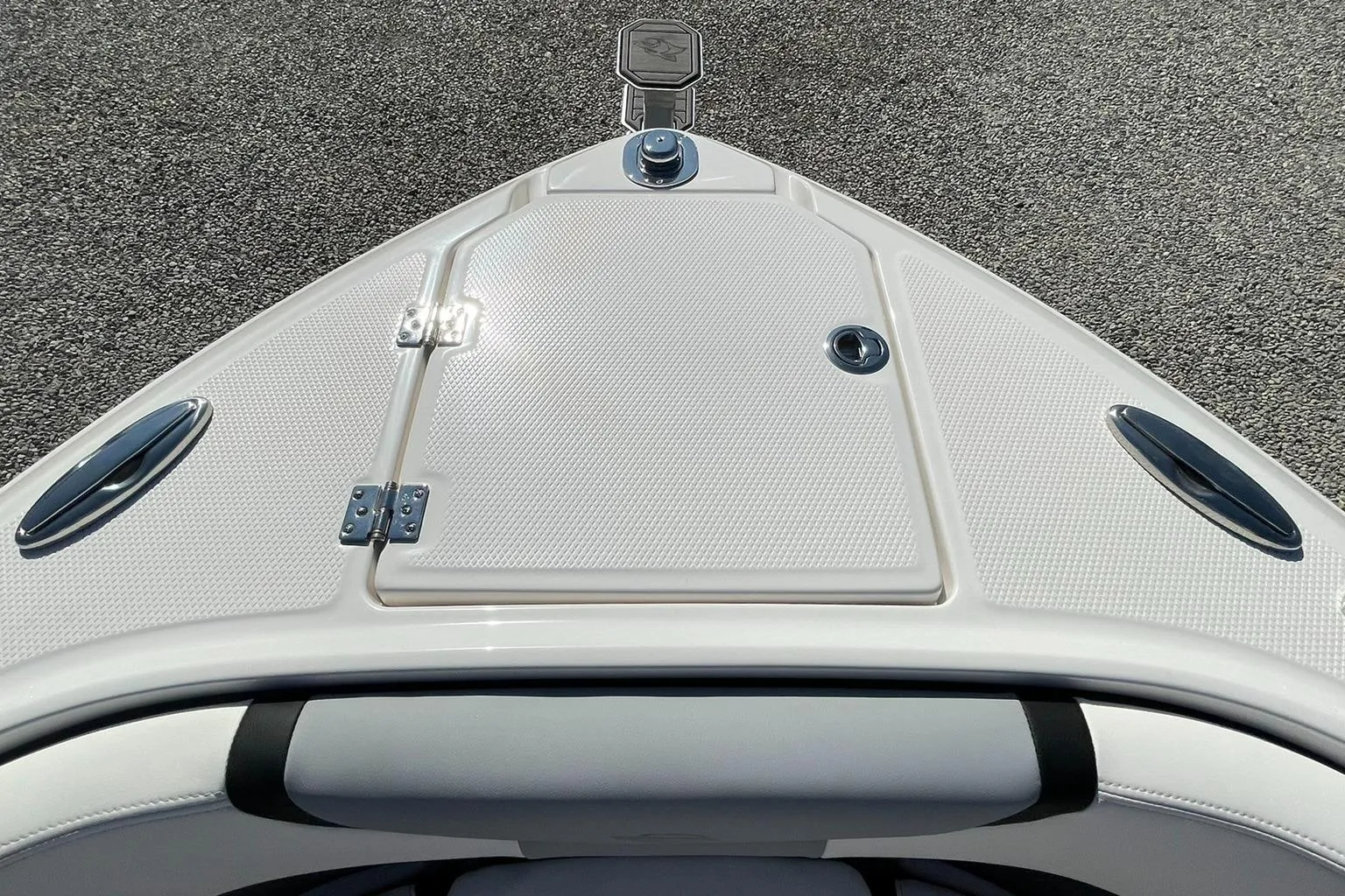 Bow view of 2025 Chaparral 270 OSX boat, featuring sleek design and storage hatch.