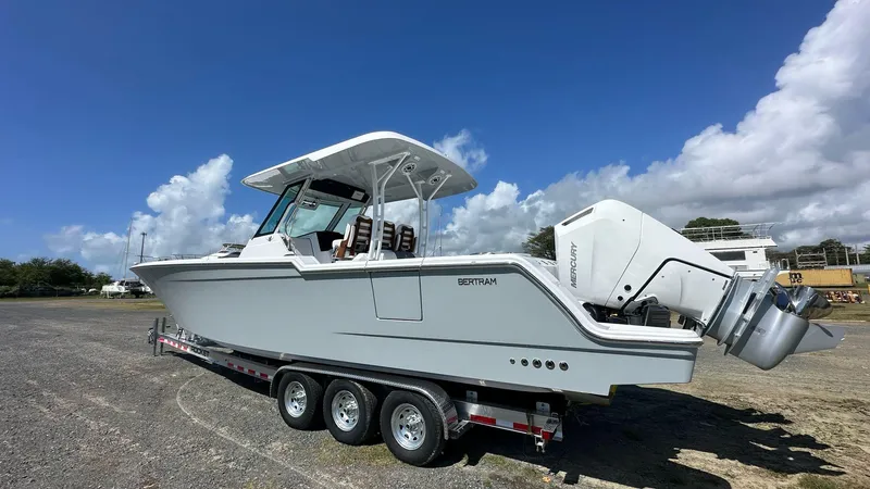  Yacht Photos Pics 2025 Bertram 34 CC boat on trailer under clear blue sky.