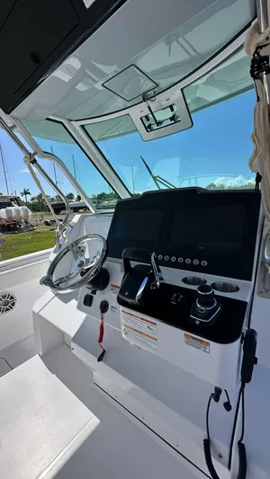  Yacht Photos Pics 2025 Bertram 34 CC boat cockpit with modern controls and steering wheel.