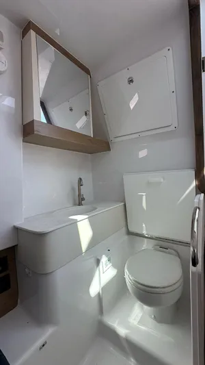  Yacht Photos Pics Modern bathroom in 2025 Bertram 34 CC boat with sleek fixtures and mirror.