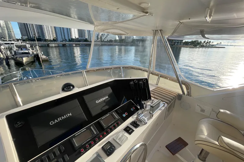 Bluewater Yacht Photos Pics 2005 Ocean Alexander Raised Pilothouse Flybridge Sedan helm with Garmin navigation, overlooking marina.