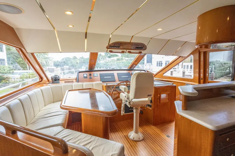 Bluewater Yacht Photos Pics Luxurious 2005 Ocean Alexander Raised Pilothouse Flybridge Sedan interior with helm and seating area.