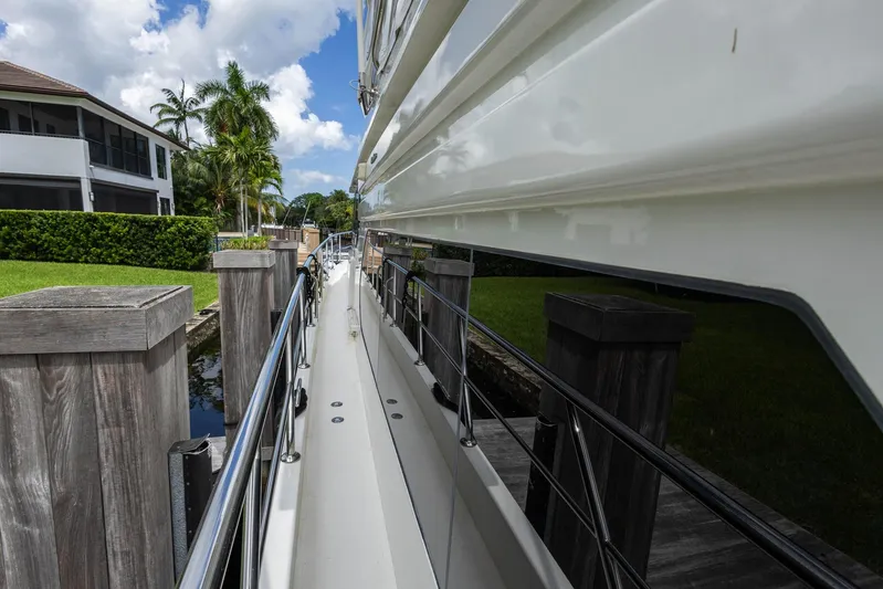 Bluewater Yacht Photos Pics 2005 Ocean Alexander Raised Pilothouse Flybridge Sedan docked by wooden posts.