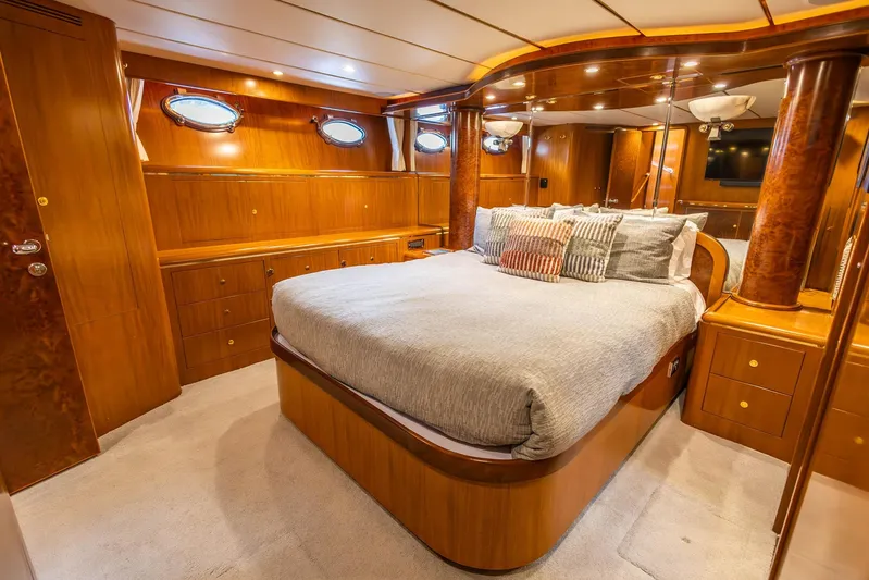 Bluewater Yacht Photos Pics Luxurious 2005 Ocean Alexander yacht bedroom with elegant wood finishes and plush bedding.