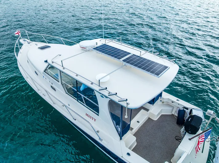 Misty Yacht Photos Pics 2007 Mainship Pilot 34 boat with solar panels on calm water.