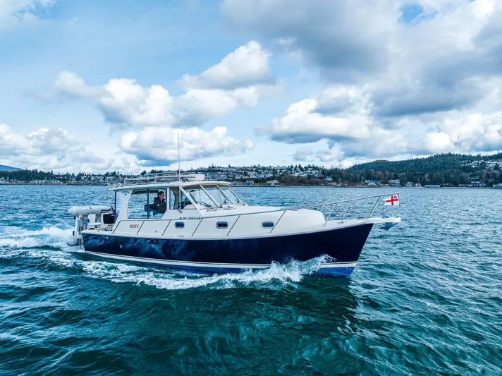 Misty Yacht Photos Pics 2007 Mainship Pilot 34 cruising on a scenic, cloudy day.