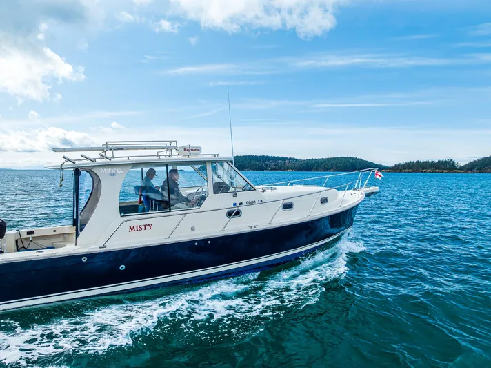 Misty Yacht Photos Pics 2007 Mainship Pilot 34 cruising on open water under a clear blue sky.