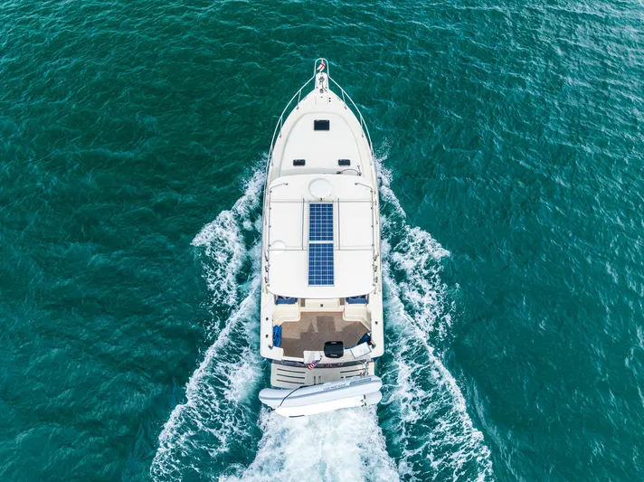 Misty Yacht Photos Pics Aerial view of 2007 Mainship Pilot 34 cruising on turquoise water.