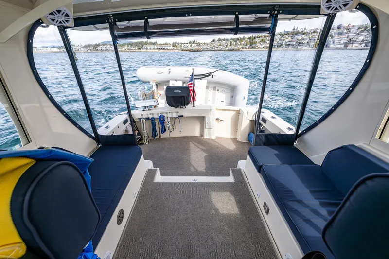 Misty Yacht Photos Pics 2007 Mainship Pilot 34 boat interior with seating, overlooking calm waters.