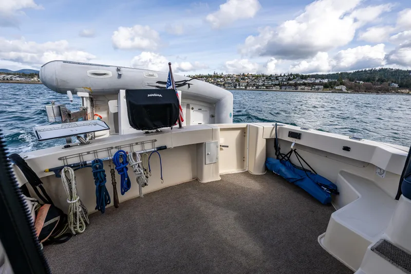 Misty Yacht Photos Pics 2007 Mainship Pilot 34 boat deck with ropes and equipment, overlooking scenic water and shoreline.