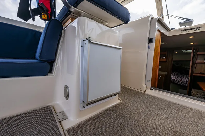 Misty Yacht Photos Pics 2007 Mainship Pilot 34 interior with seating, carpet, and cabin entrance.