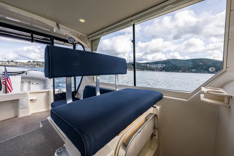 Misty Yacht Photos Pics 2007 Mainship Pilot 34 interior with blue seating, scenic lake view.